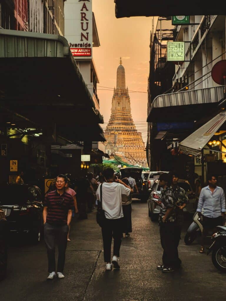Street view of a temple spire at sunset in Thailand