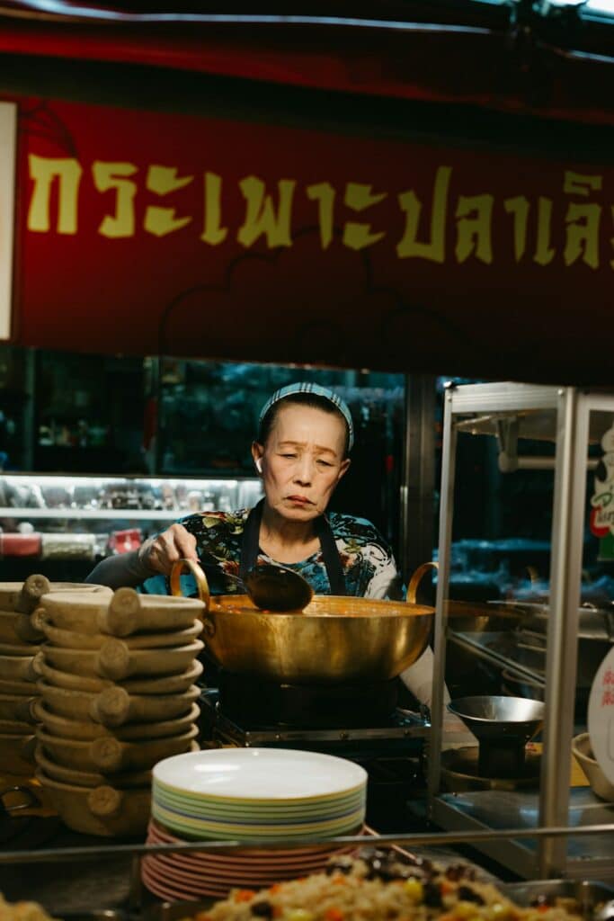 Street food vendor cooking at a stall in Bangkok