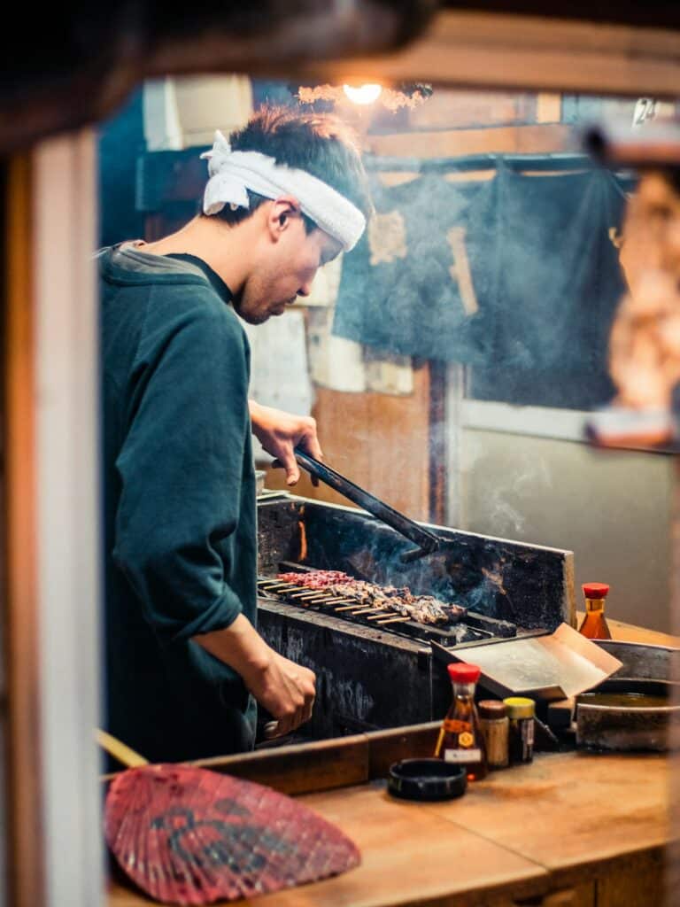 Chef preparing food at Shinjuku Market in Tokyo