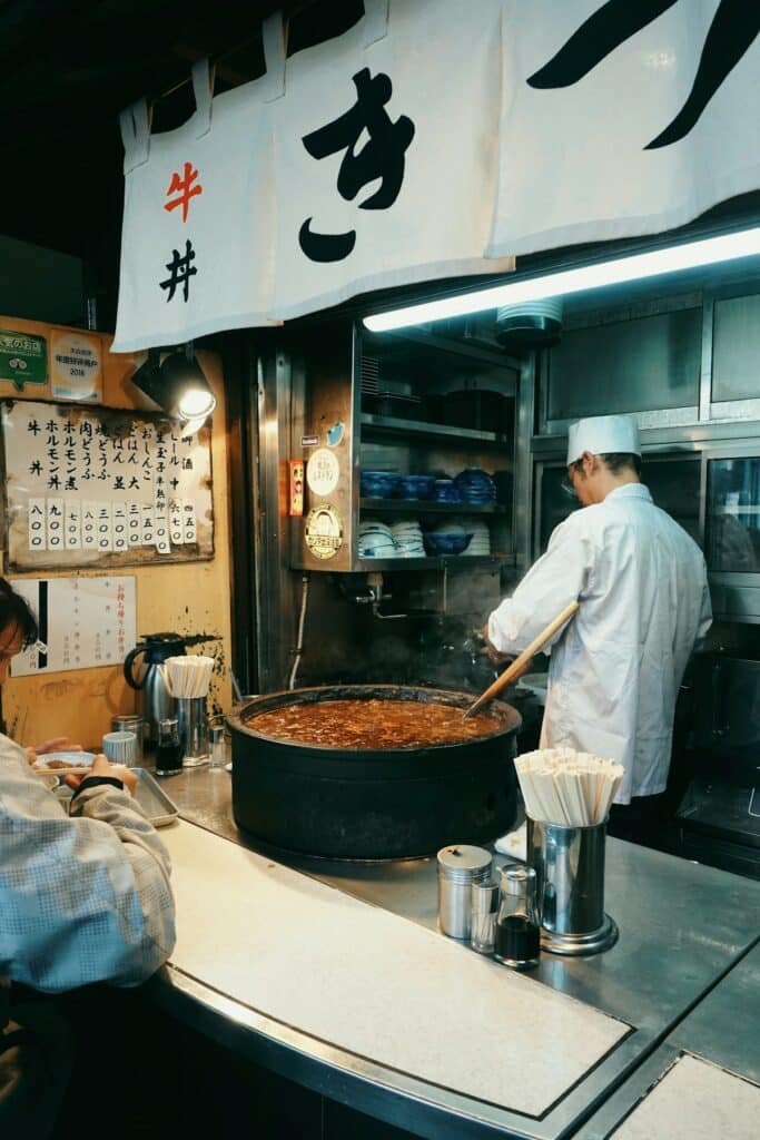 Chef cooking in a traditional Japanese kitchen