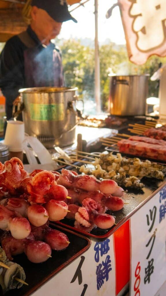 Street food stalls lit up in a Tokyo alley