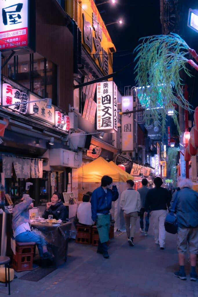 Travelers walking through a Tokyo street at night