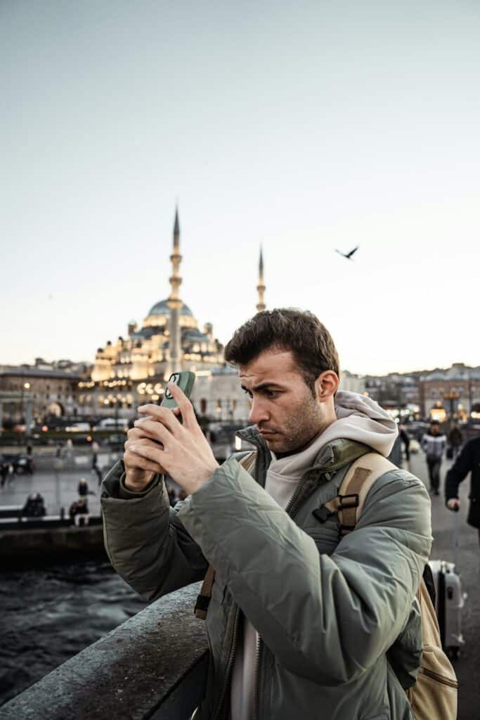 man taking a picture with his cell phone outdoors