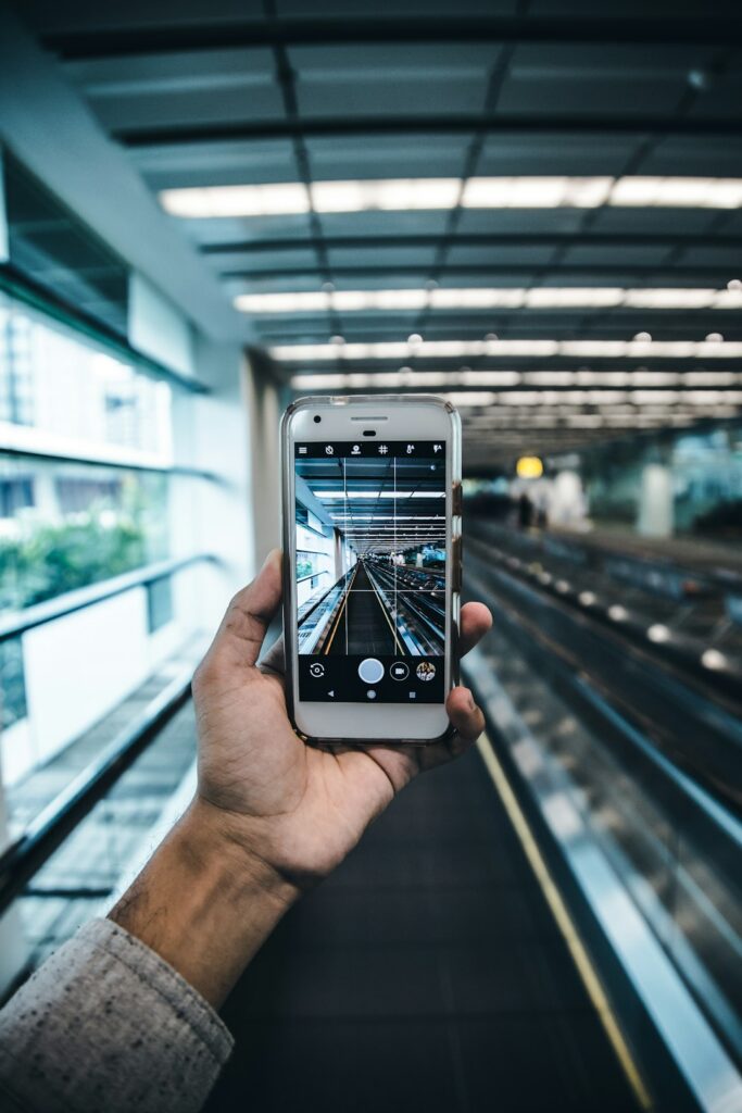 Traveler holding a smartphone while checking mobile data settings